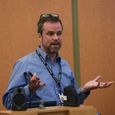Kirby Callum speaking at a D65 School Board meeting